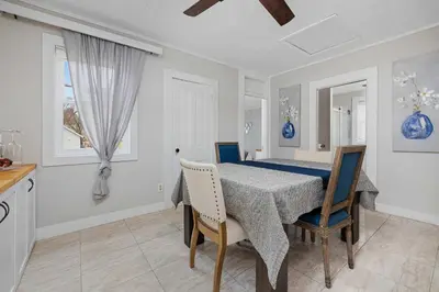 a kitchen and dining room with a table and chairs at Vintage West Central Apt Walkable Free Parking! in Fort Wayne