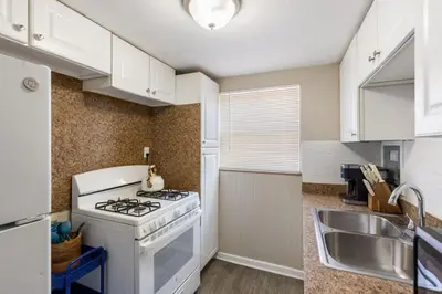 a kitchen with a stove and a sink at Heights Sweet - Libby Unit 7 in Maple Heights