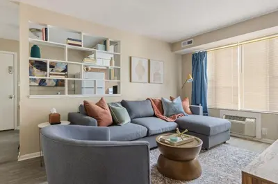 a living room with a blue couch and chairs at Heights Sweet - Libby Unit 7 in Maple Heights
