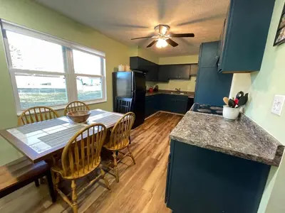 a kitchen and dining room with a table and chairs at Blue Heron Cottage with Game Room, Deck, Hot Tub in Logan