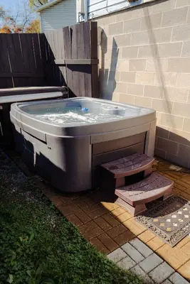 a hot tub sitting outside of a house at Blue Heron Cottage with Game Room, Deck, Hot Tub in Logan