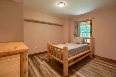 a bedroom with a bed and a window at Tranquil Heights Cabin in Hocking Hills in Ray