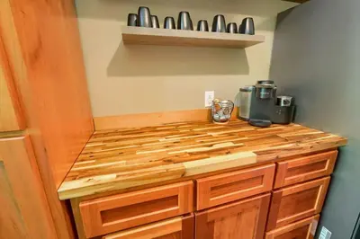 a kitchen with a wooden counter top with utensils at Tranquil Heights Cabin in Hocking Hills in Ray