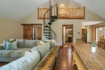 a living room with a couch and a wooden table at Tranquil Heights Cabin in Hocking Hills in Ray