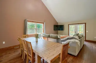 a living room with a wooden table and a couch at Tranquil Heights Cabin in Hocking Hills in Ray