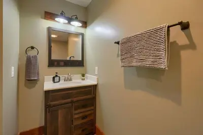 a bathroom with a sink and a mirror at Tranquil Heights Cabin in Hocking Hills in Ray