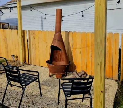 a grill with a pot and two chairs and a fence at Joyful Bright1-BR , Fenced Pet Friendly Yard With Garage in Dayton