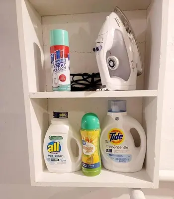 a white shelf with somecellaneous items in a cabinet at Joyful Bright1-BR , Fenced Pet Friendly Yard With Garage in Dayton