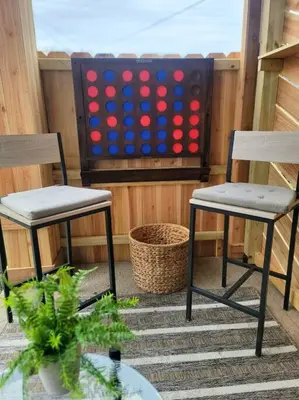 two chairs and a ping pong game on a porch at Joyful Bright1-BR , Fenced Pet Friendly Yard With Garage in Dayton