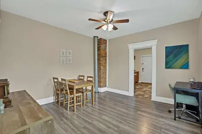 a living room with a ceiling fan and a table at The Rich Street Getaway in Columbus
