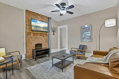 a living room with a couch and a fireplace at The Rich Street Getaway in Columbus