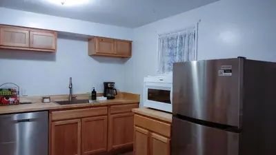 a kitchen with a stainless steel refrigerator and wooden cabinets at Entire House in Twinsburg in Twinsburg