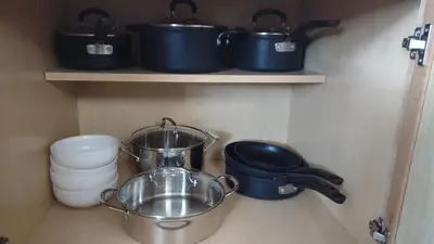 a kitchen with pots and pans and plates on shelves at Entire House in Twinsburg in Twinsburg