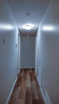 an empty hallway with white walls and wooden floors at Entire House in Twinsburg in Twinsburg
