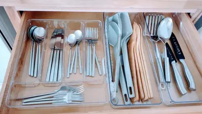 a plastic drawer filled with utensils in a cabinet at Entire House in Twinsburg in Twinsburg