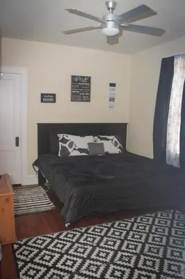 a bedroom with a bed with a ceiling fan at Charming 1 BR Apt 6 miles from Downtown! in Cincinnati