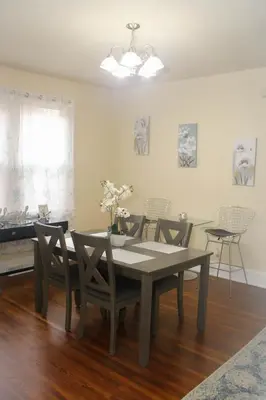 a dining room with a table and chairs and a piano at Charming 1 BR Apt 6 miles from Downtown! in Cincinnati
