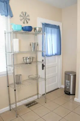 a kitchen with a shelf with bowls on it at Charming 1 BR Apt 6 miles from Downtown! in Cincinnati