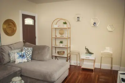 a living room with a couch and a shelf at Charming 1 BR Apt 6 miles from Downtown! in Cincinnati