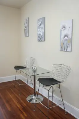 two chairs and a glass table in a room at Charming 1 BR Apt 6 miles from Downtown! in Cincinnati