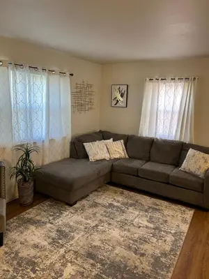 a living room with a couch and two windows at Cozy Apartment 6 miles from Downtown, Cincinnati in Cincinnati