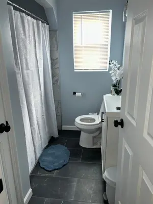 a blue bathroom with a toilet and a sink at Cozy Apartment 6 miles from Downtown, Cincinnati in Cincinnati