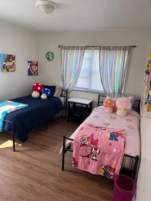 a bedroom with two beds and a window at Cozy Apartment 6 miles from Downtown, Cincinnati in Cincinnati