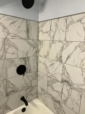 a bathroom with a shower with marble tiles at Cozy Apartment 6 miles from Downtown, Cincinnati in Cincinnati