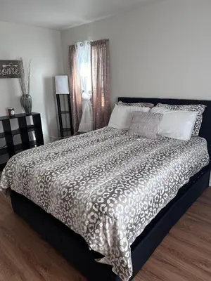 a bedroom with a large bed with a comforter at Cozy Apartment 6 miles from Downtown, Cincinnati in Cincinnati