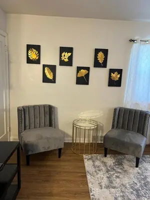 two chairs and a table in a living room at Cozy Apartment 6 miles from Downtown, Cincinnati in Cincinnati