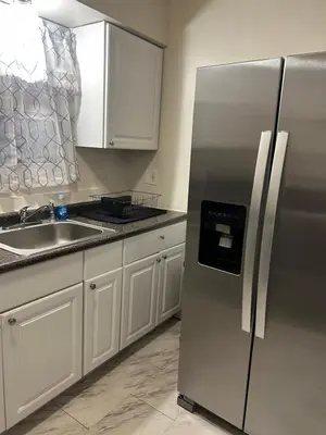 a kitchen with a stainless steel refrigerator and a sink at Cozy Apartment 6 miles from Downtown, Cincinnati in Cincinnati