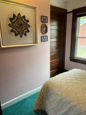 a bedroom with a bed and a clock on the wall at Pendleton Getaway in Pendleton