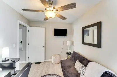a living room with a couch and a ceiling fan at 8 Mi to Dtwn Cleveland Family Home in Cleveland