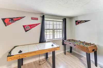 a game room with a ping pong table and a table at 8 Mi to Dtwn Cleveland Family Home in Cleveland