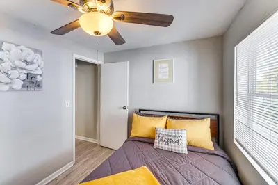 a bedroom with a bed with a ceiling fan at 8 Mi to Dtwn Cleveland Family Home in Cleveland