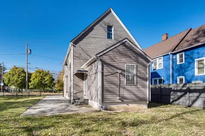 a brown house with a blue building next to it at 8 Mi to Dtwn Cleveland Family Home in Cleveland