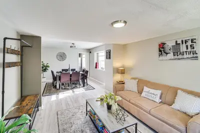 a living room with a couch and a table at 8 Mi to Dtwn Cleveland Family Home in Cleveland