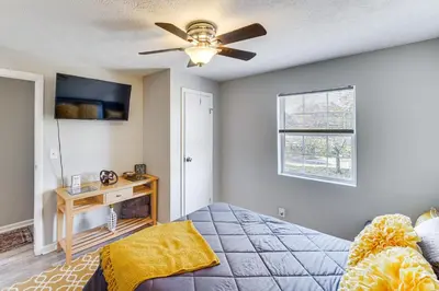a bedroom with a bed and a ceiling fan at 8 Mi to Dtwn Cleveland Family Home in Cleveland