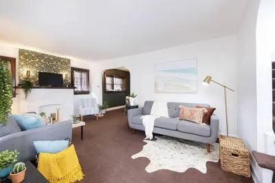 a living room with a couch and a fireplace at Cozy & Convenient Getaway 3BD 2BA Dog Friendly in Akron