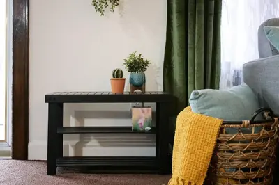 a black table with plants on it next to a couch at Cozy & Convenient Getaway 3BD 2BA Dog Friendly in Akron