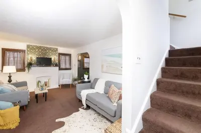 a living room with a couch and a fireplace at Cozy & Convenient Getaway 3BD 2BA Dog Friendly in Akron