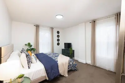 a bedroom with a bed and a window at Cozy & Convenient Getaway 3BD 2BA Dog Friendly in Akron