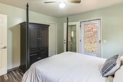 a bedroom with a bed and a ceiling fan at 1 Mi to Hunting Cozy and Secluded Stout Cabin in Stout