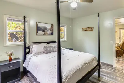 a bedroom with a four poster bed and a window at 1 Mi to Hunting Cozy and Secluded Stout Cabin in Stout