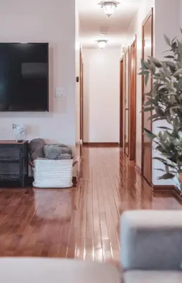 a living room with a couch and a flat screen tv at Bigfoot's Hideout - A Hocking Hills Escape in Logan