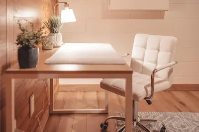 a white chair sitting at a desk in a room at Bigfoot's Hideout - A Hocking Hills Escape in Logan