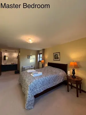 a bedroom with a bed with a master bedroom at Bluegrass Resort - Nature rich escape, Between the Creation & ARK, Fully equipped kitchen, Pet friendly, Fire pit in Union