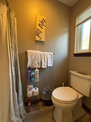 a bathroom with a toilet and towels and a window at Bluegrass Resort - Nature rich escape, Between the Creation & ARK, Fully equipped kitchen, Pet friendly, Fire pit in Union