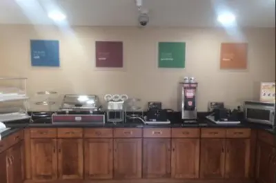 a kitchen with wooden cabinets and appliances on the wall at Comfort Inn & Suites Caldwell in Caldwell
