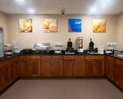 a salon with wooden cabinets and a counter top at Comfort Inn & Suites Caldwell in Caldwell